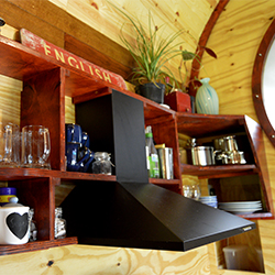 Storage, shelving and extractor fan above the kitchen hob